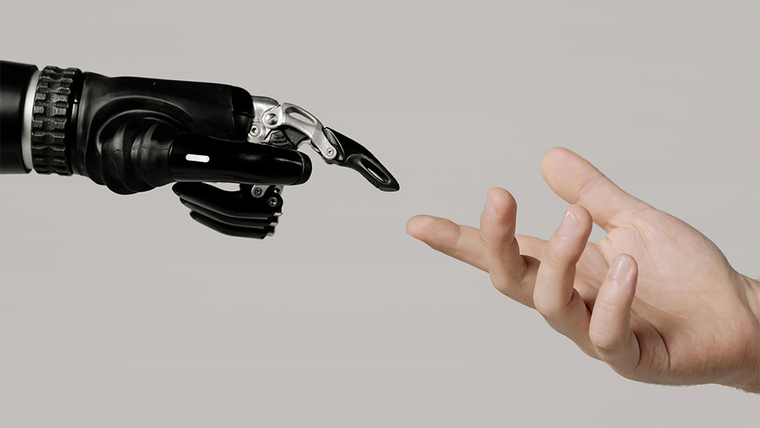 A robot hand reaching out to touch a human hand