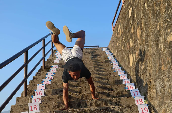 Hari walking down the stairs on his hands