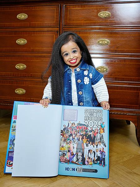 Jyoti showing book and smiling