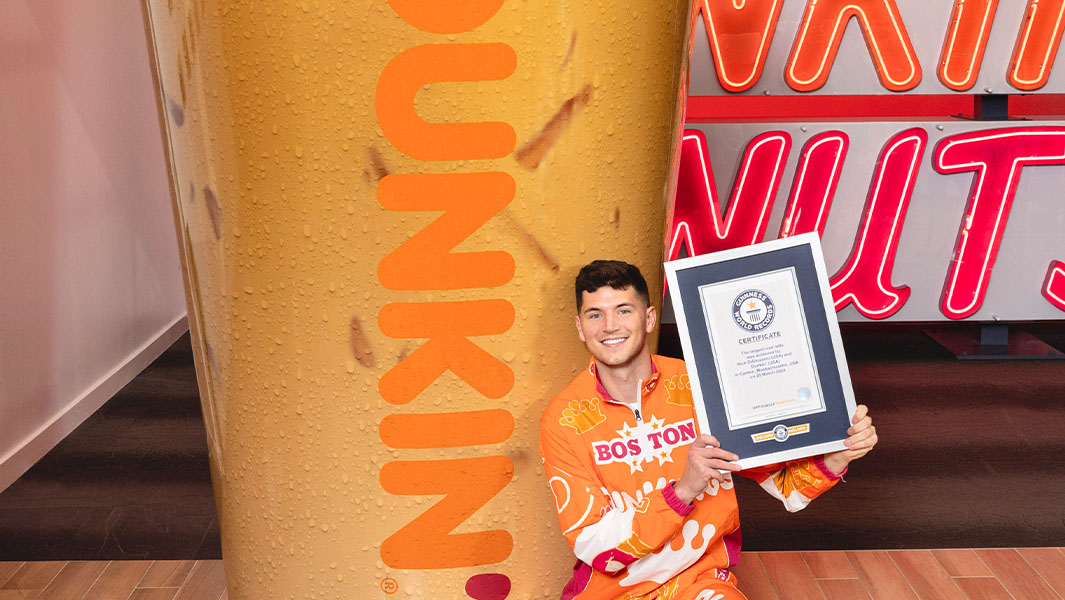 Close up of Nick DiGiovanni with the largest iced latte and his GWR certificate