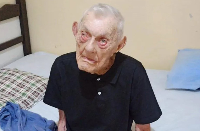 Joao sitting on a bed
