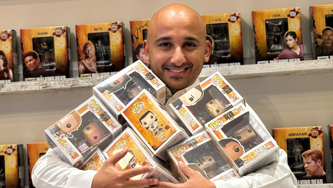 Rashid holding some of his The Walking Dead Funko Pops!