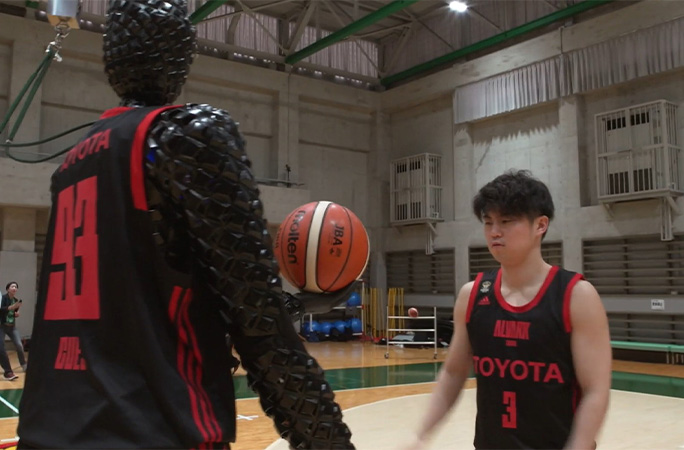 basketball robot being handed a ball