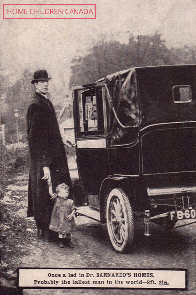Frederick standing by a car with a child