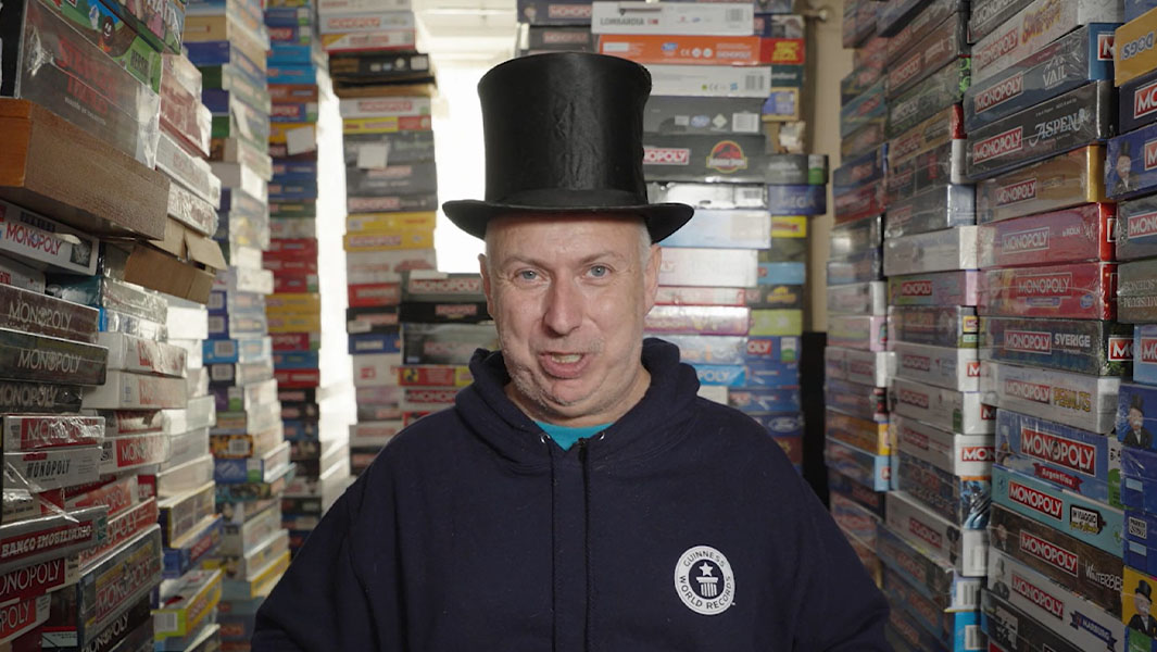 Neil Scallan surrounded by Monopoly sets