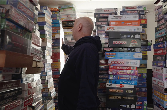 Neil standing next to some of his Monopoly sets