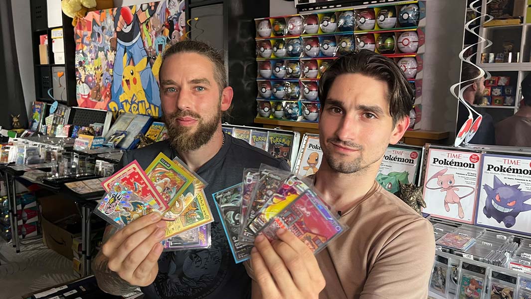 Owen and Conner hold up some Pokemon cards