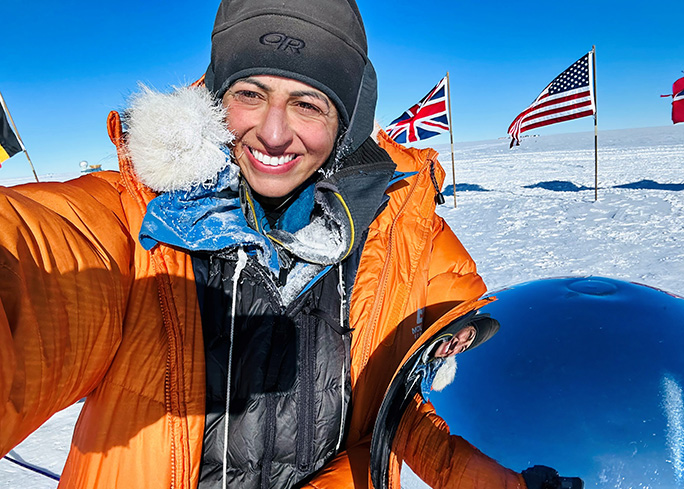 Preet in the sun with an orange jacket