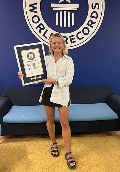 Imogen standing with her certificate 