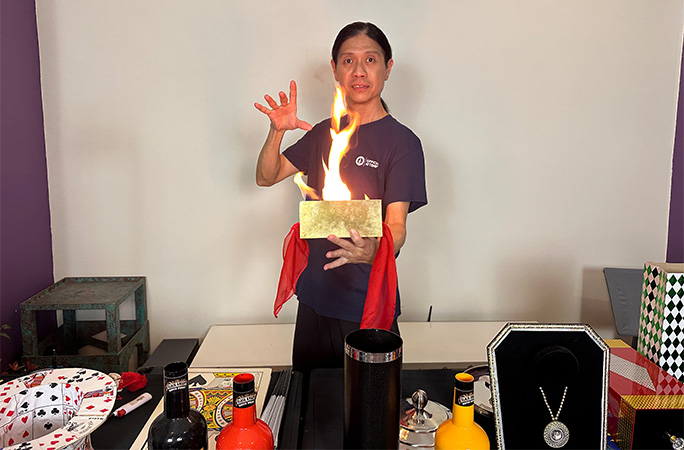 Avery Chin holding a box that's on fire