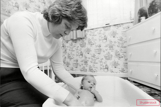 Baby Louise being bathed by mother