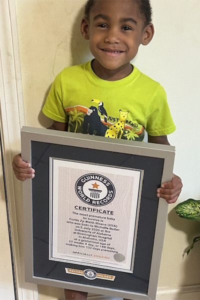 Curtis now, holding his certificate