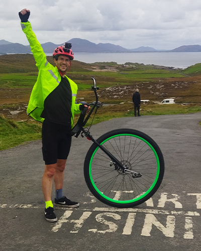 Eamonn standing next to unicycle