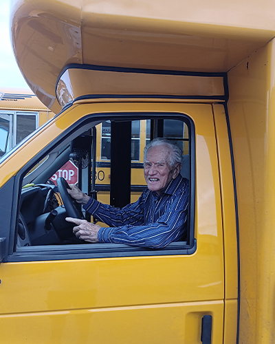 James sitting inside yellow school bus