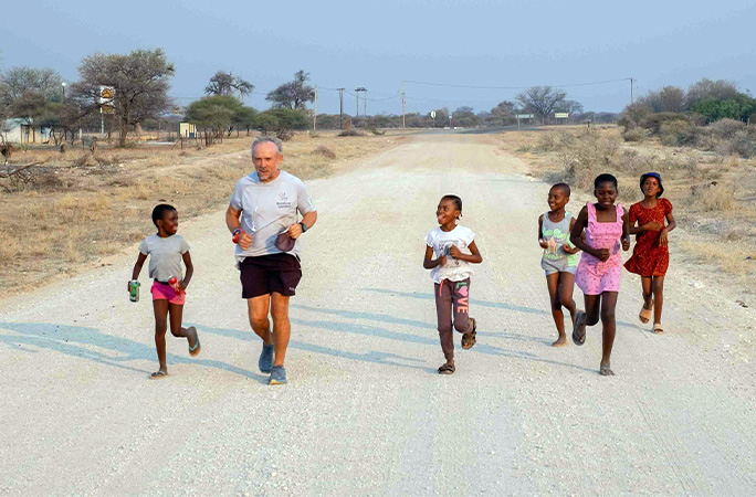 Keith running with African children