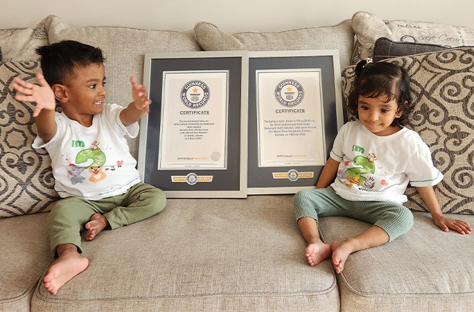 Adiah and Adrial sitting next to GWR certificate