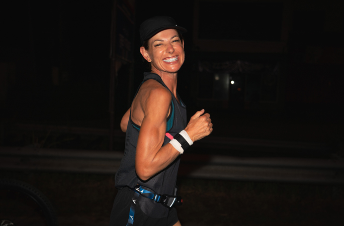 Natalie Dau smiles to the camera as she runs