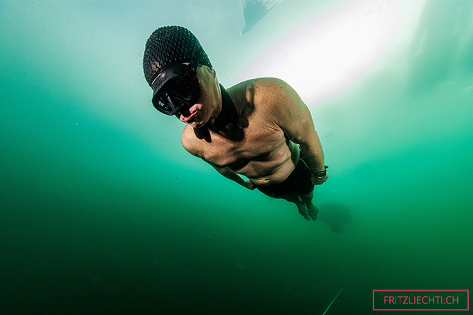 Close up of PEter swimming under ice