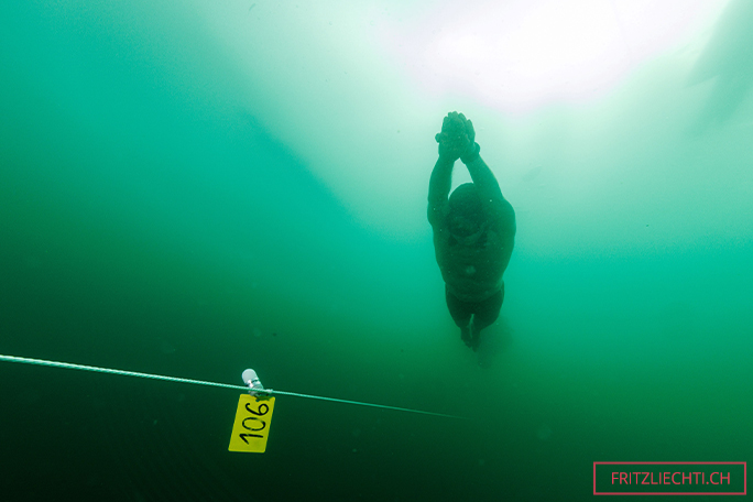 Peter swimming arms forward under ice