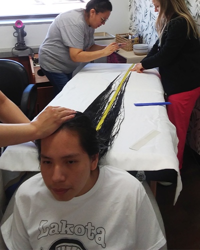 Reuben having his hair measured