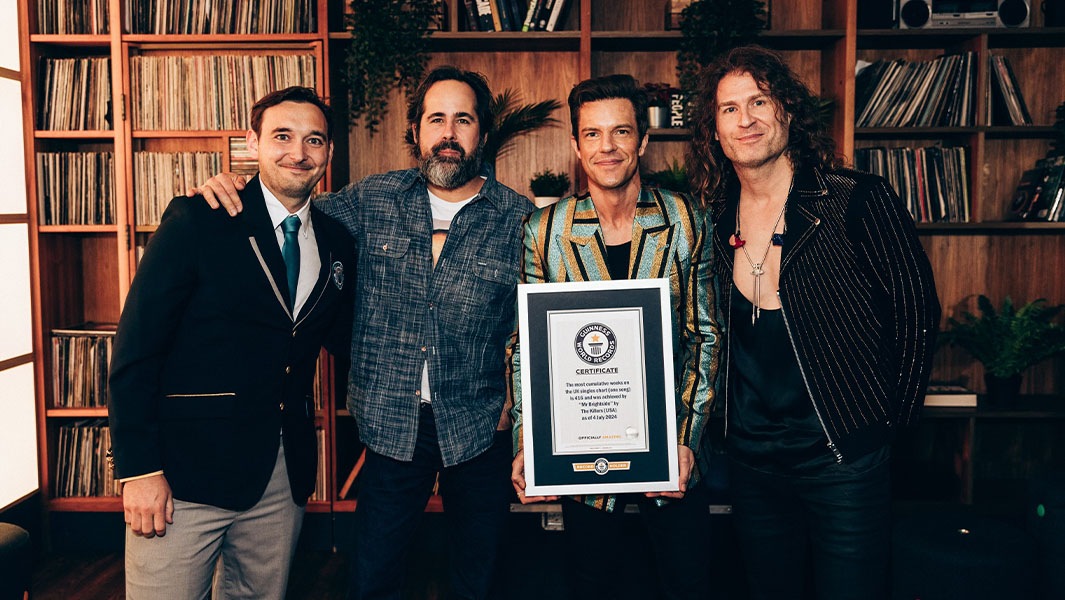 The Killers accept a certificate from Guinness World Records Adjudicator Will Munford