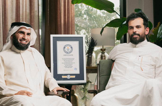 Abdulrahman Bu Maleh and Yasser Al Hazimi sitting next to the GWR certificate