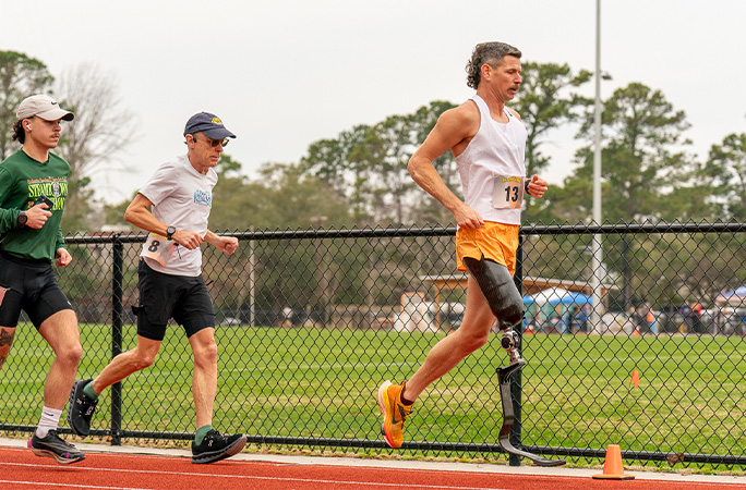 Adam running in front of two people