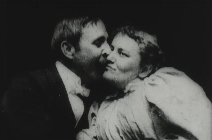 The man kisses the woman on the cheek