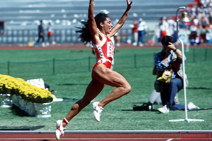 Griffith Joyner sprinting arms in air