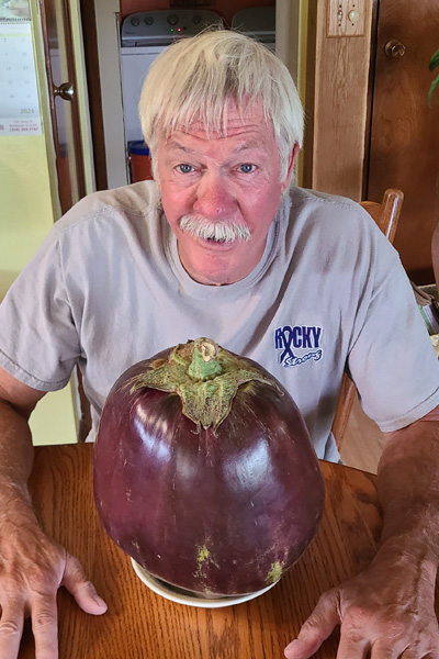 heaviest eggplant on a plate with grower dave bennett from iowa