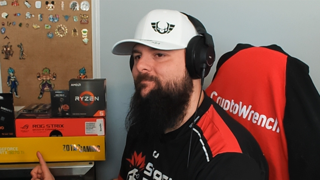 Justin sitting in a gaming chair wearing a cap