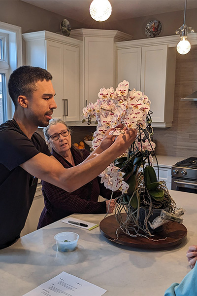 Kevin counting the flowers on his orchid