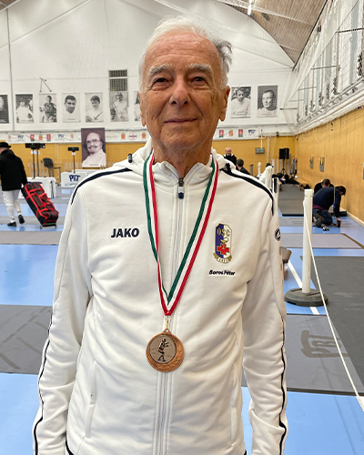 Peter posing while wearing a medal