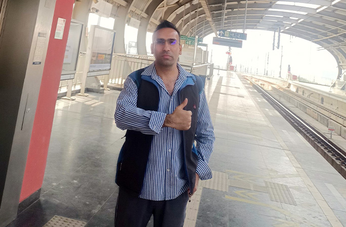 Shashank standing on train platform