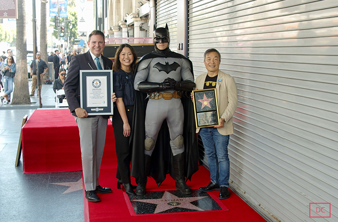 GWR's Michael Empric presents a certificate to Anne DC's Anne DePies, Jim Lee and Batman 
