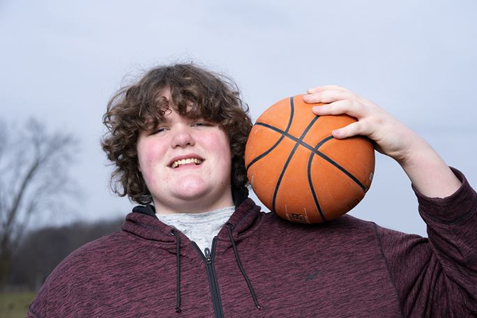 Eric smiling and holding a ball