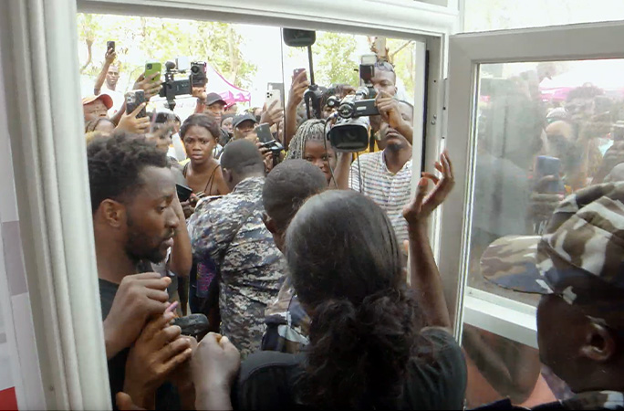 Mary waving to large crowd outside