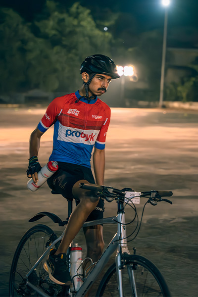 Vaibhav cycling and holding a water bottle