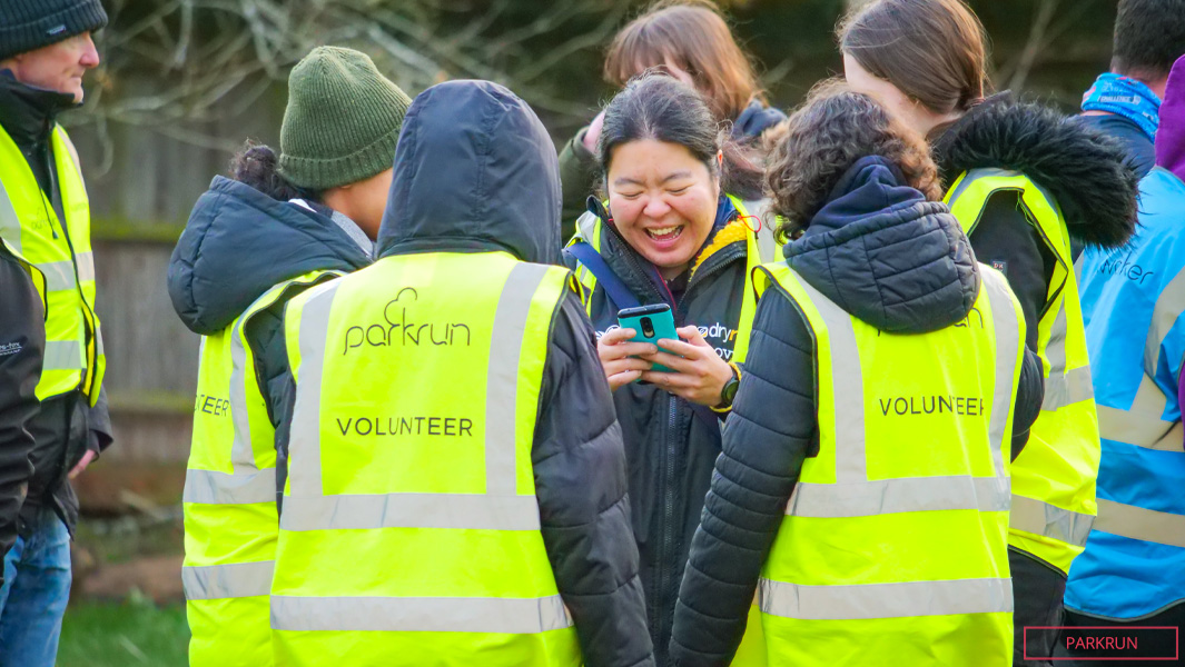 Parkrun volunteers standing in a circle talking