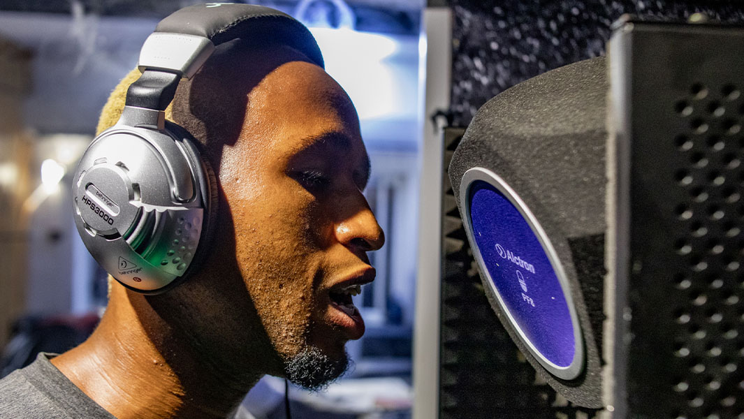 Split image of singer at mic and Idem at his desk