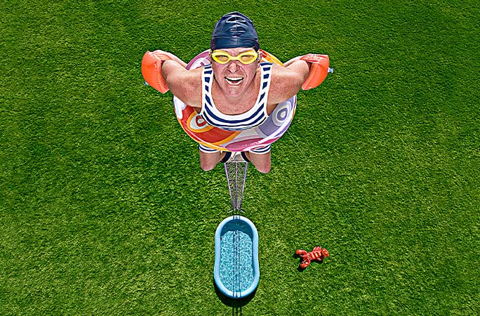 Darren Taylor sitting high above a tiny swimming pool