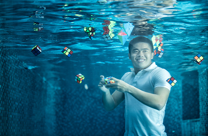 Daryl underwater solving puzzle cubes