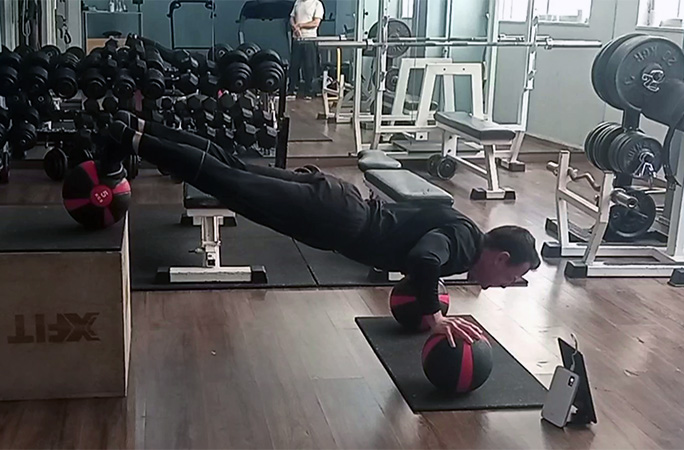 George doing push ups on medicine balls with a decline