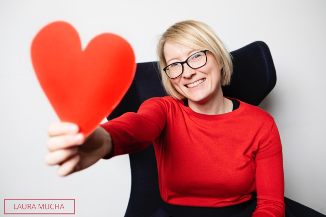 Laura with heart smiling