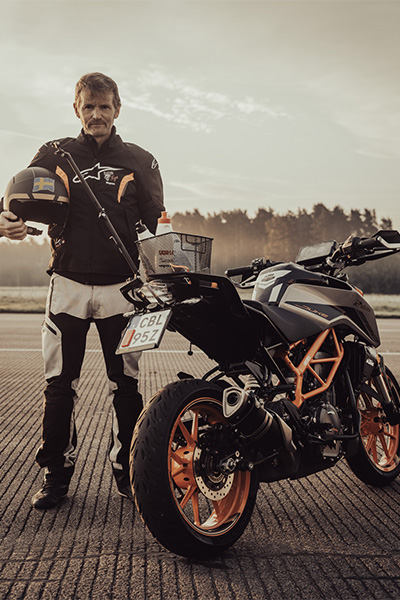 Magnus standing with his bike