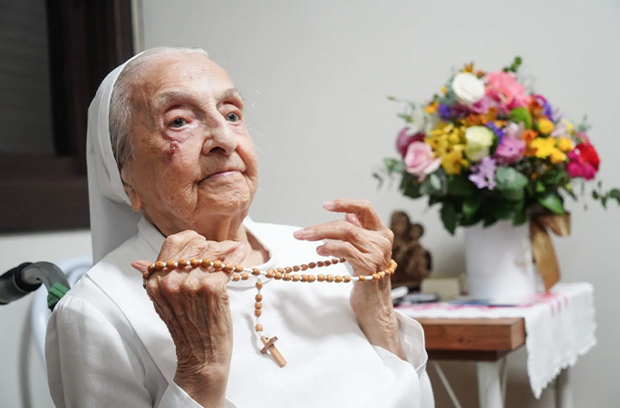 Inah holding rosary beads