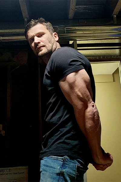 Paul Boland flexing his arm muscles