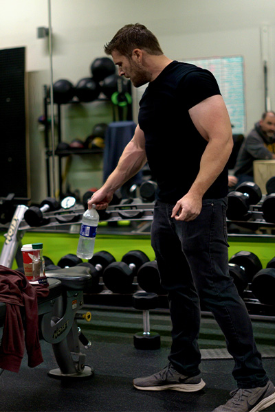 Paul Boland standing by weights in the gym