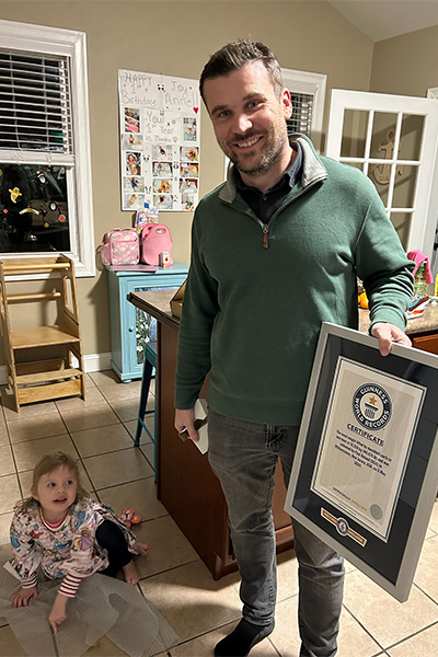 Paul Boland with his daughter and his record certificate