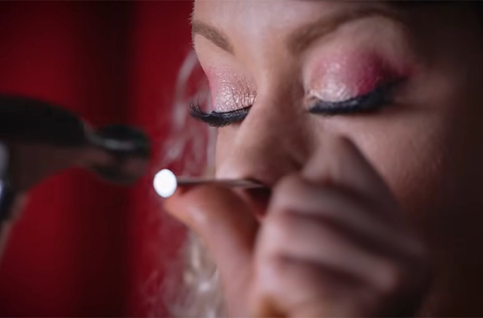 Daniella hammering a nail in her nose